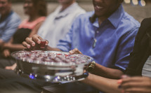 passing a tray of communion cups during a worship service 