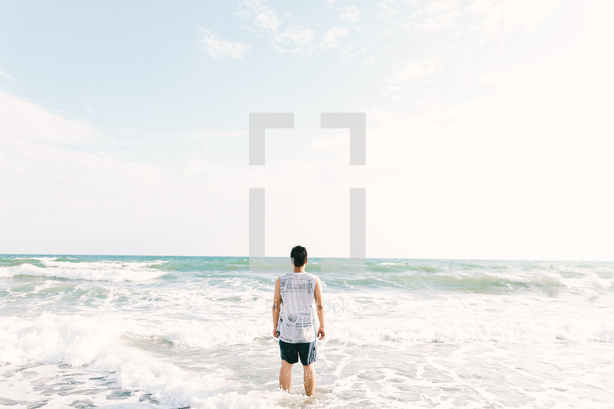 man standing in the surf 