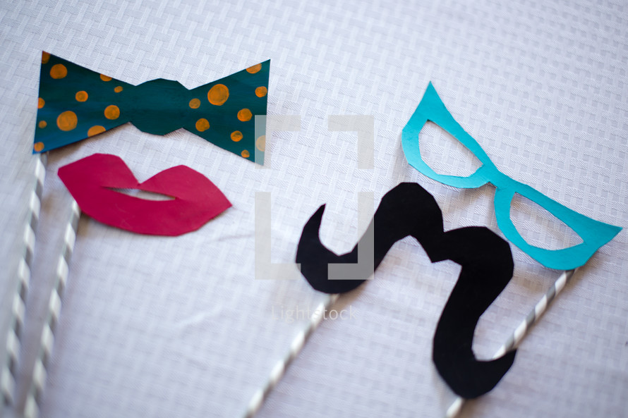 Lips, mustache, bow tie and glasses party favors.