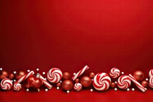 Christmas background with red and white candies, lollipops and red balls
