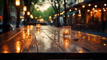 Glass of whiskey on a wooden table in the street at night.