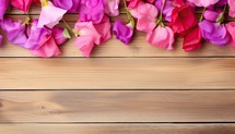 Colorful petals on wooden background. Top view with copy space