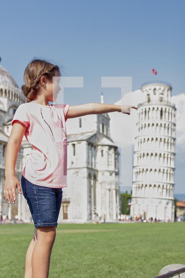 girl pointing near the Leaning Tower of Pisa 