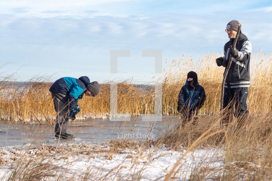 kids playing hockey on a frozen pond 