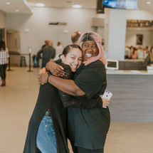 a mother hugging her teen daughter after church 
