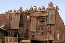 pots on roofs of a clay hut 