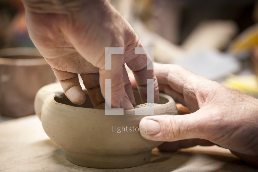 shaping clay with hands 