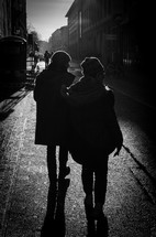 Couple walking along a stone street.