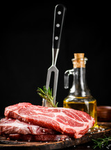 Raw pork steak on a stone board. On a black background. High quality photo