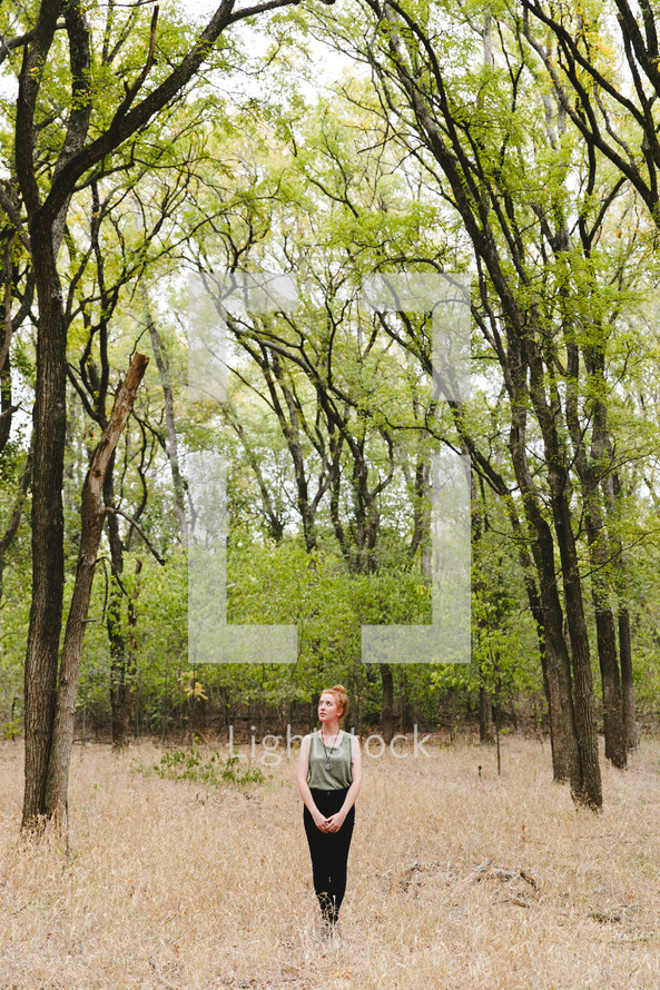 woman standing outdoors in a forest 
