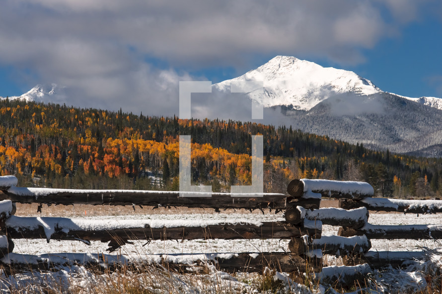 Snow covered mountain above autumn colors