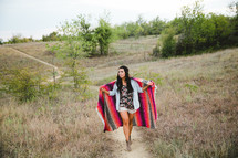 woman wrapped in a blanket outdoors 