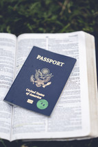 passport on the pages of an open Bible 
