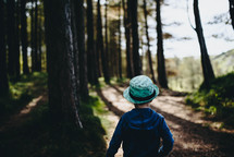 a boy walking along a path 