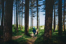 a boy walking through a forest 