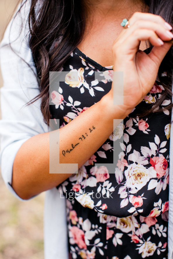 tattoo of Psalm 93:16 on a woman's arm 