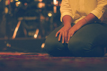 a woman on the floor with her hands on her knees