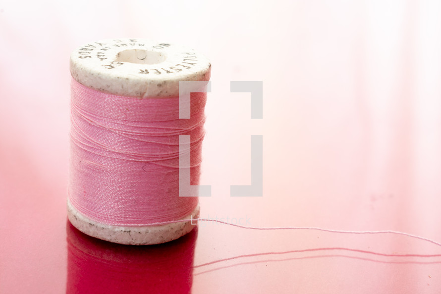 spool of pink thread 