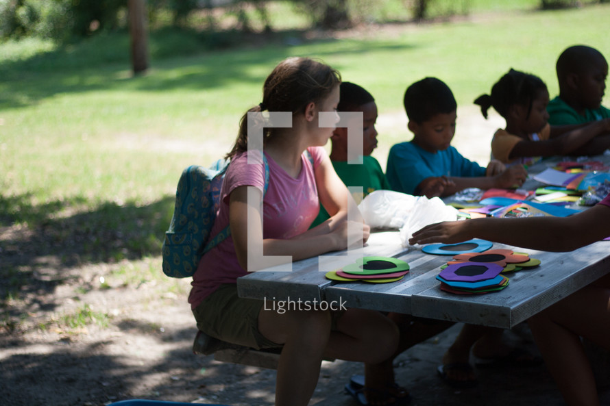 Children doing crafts on a mission trip. 