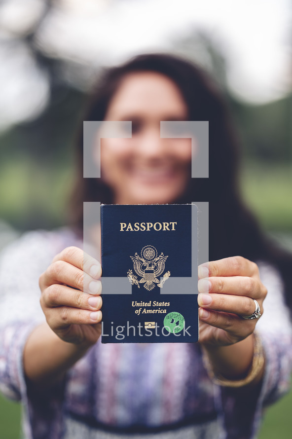 a woman holding a passport 