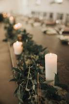Table decoration for a wedding with candles and garland