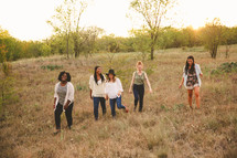 field, walking, friends, friendship, African American, woman, standing, together, outdoors, young women