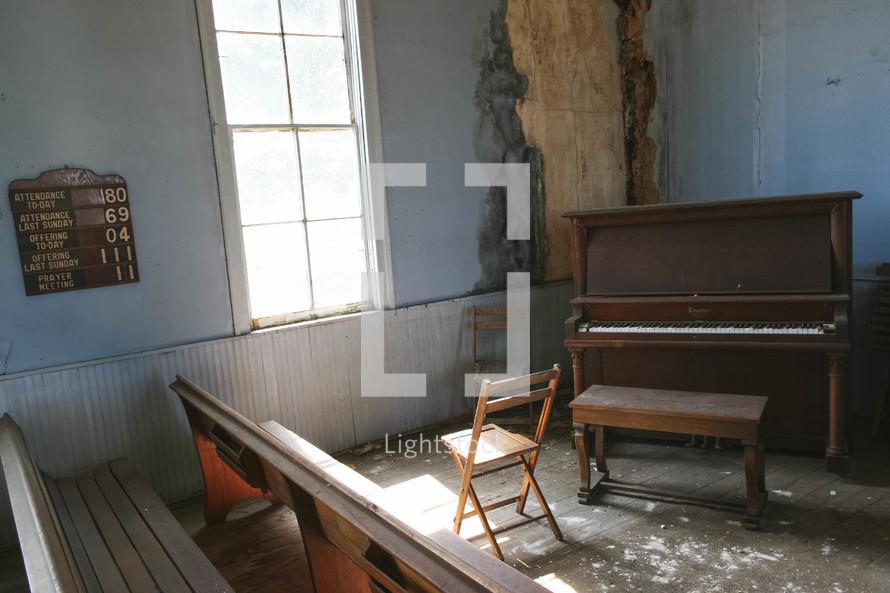 piano in the corner of an old church 