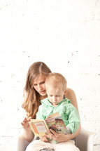 mother and son reading a book together