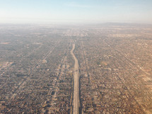 aerial view over a highway and suburbs 