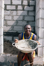 man holding a large bowl in Nigeria 