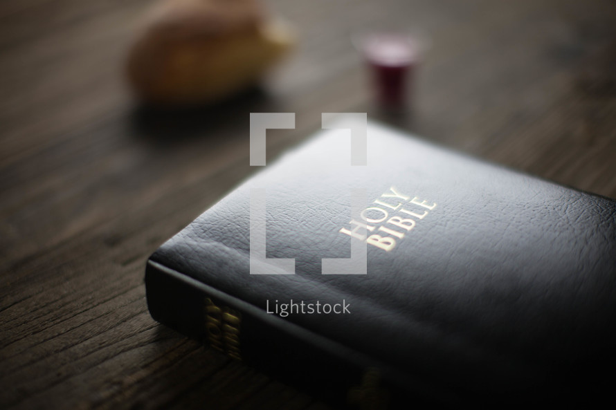 A leather Bible on a woodgrain table.