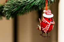 red bird ornament on a Christmas tree 