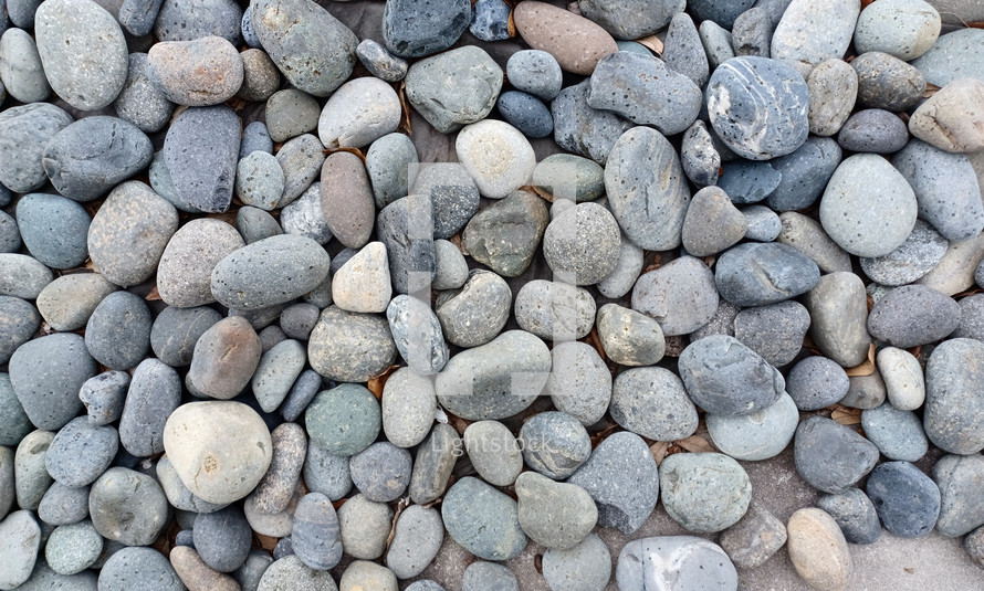 A background image of round stones grey, blue and white in color. 
