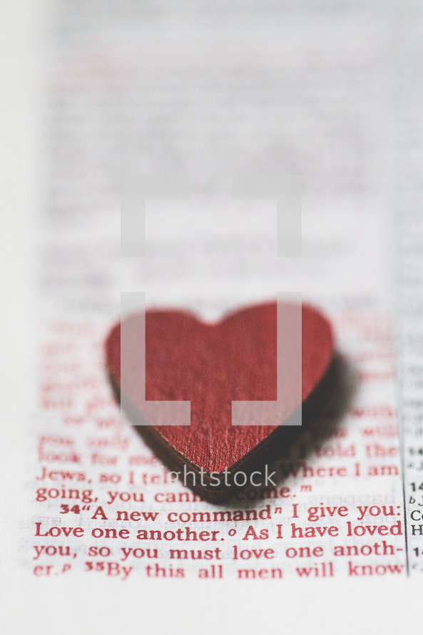 red heart shape on the pages of a Bible 