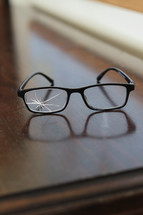 broken glasses on a wood table