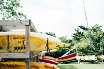 stacked kayaks in storage 