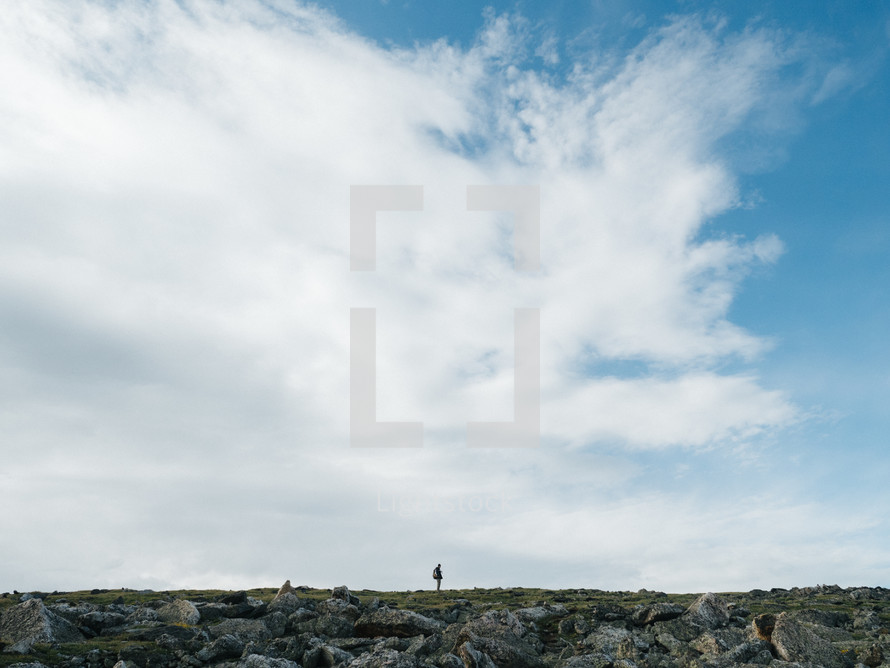 man standing on a rocky mountaintop 