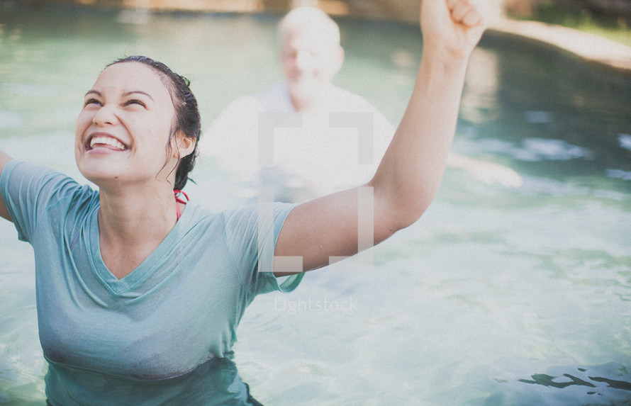 Joyous woman giving praise after being baptized.