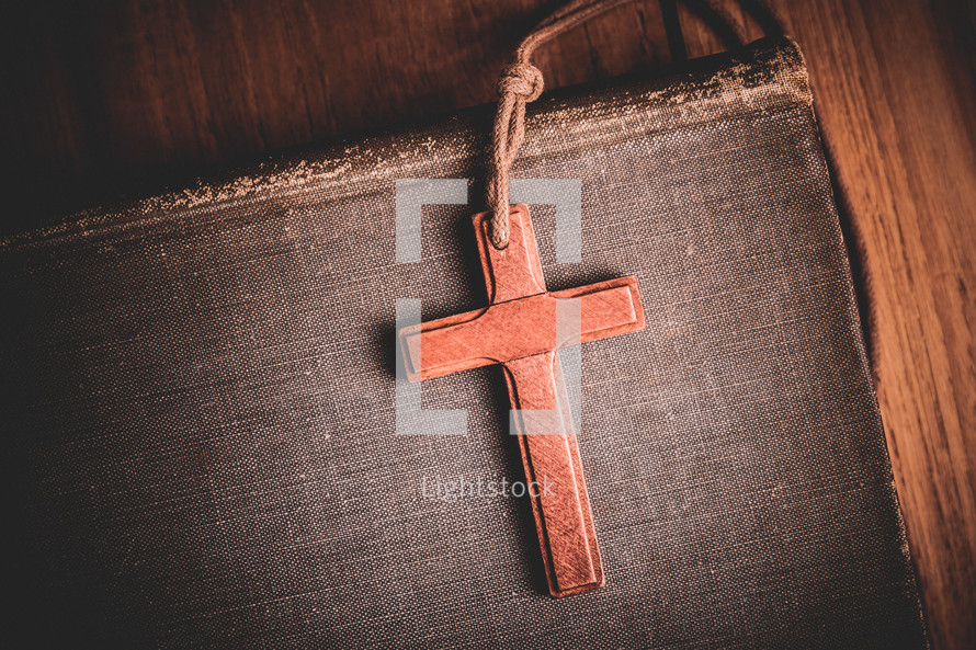 a wooden cross lanyard on a Bible 