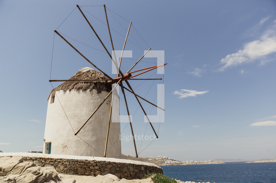 A windmill by the sea.