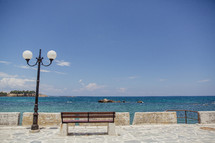 street lamp and bench near the ocean in Greece  