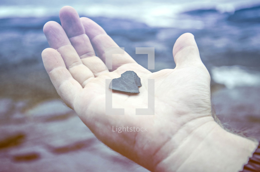 heart shaped rock in palm of the hand 