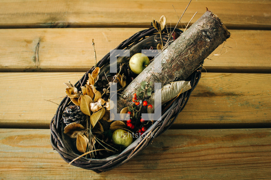 a fall centerpiece, logs in a basket 