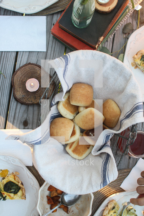 Overview of baskets of food on a picnic table.