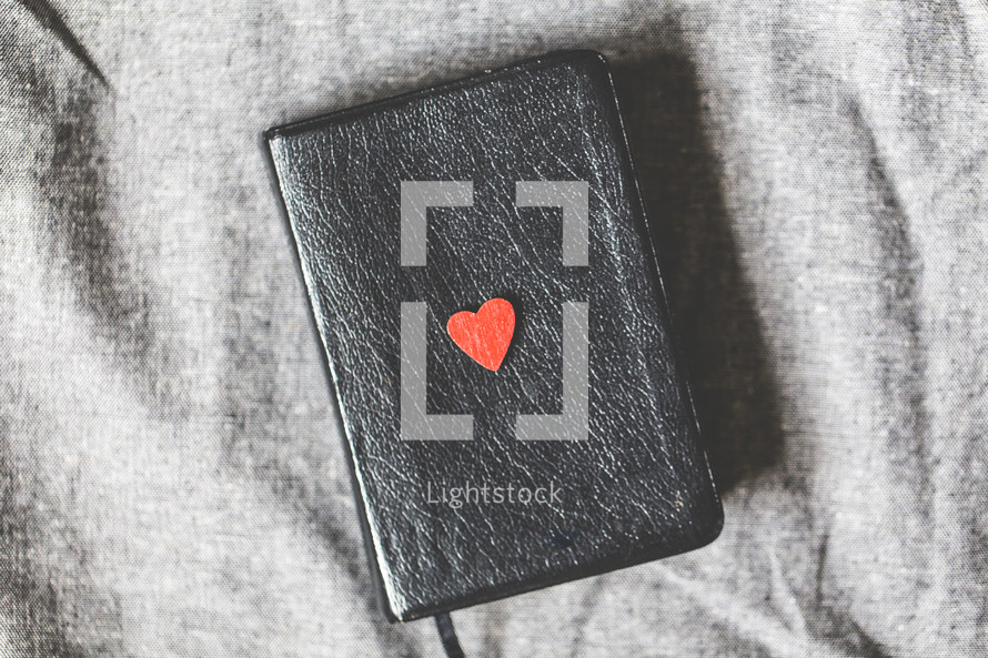 red heart on the cover of a Bible 
