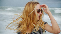 a happy young woman on a beach 