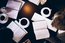 open Bibles and coffee mugs at a Bible study