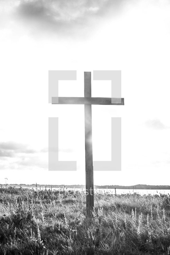 a wood cross on a hilltop 