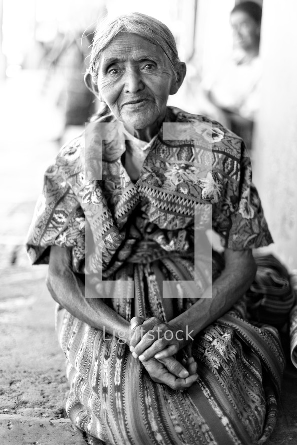 Elderly woman with folded arms