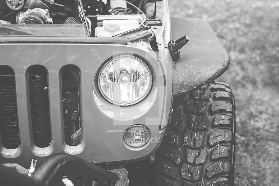 headlights and tires of a Jeep 